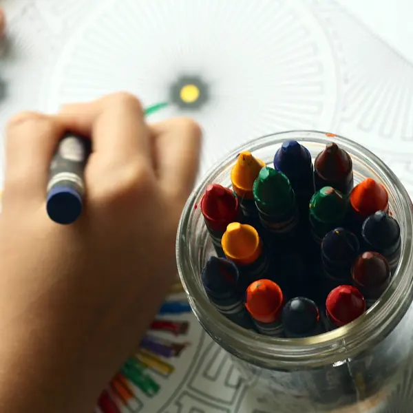 Child coloring with crayons