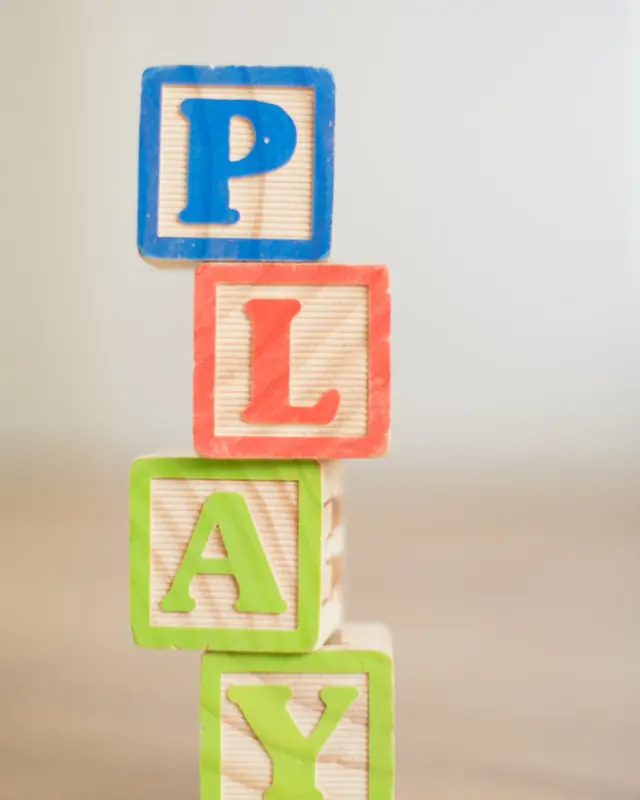 Wooden blocks stacked to spell PLAY