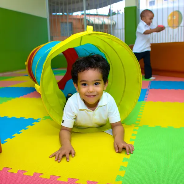 Toddler crawling through a play tunnel